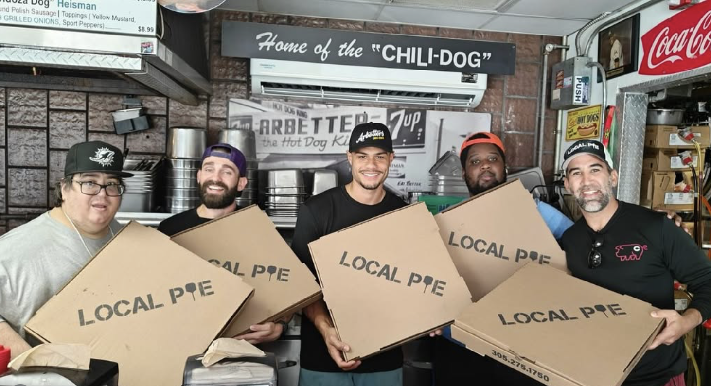 Local Pie team with pizza boxes at the shop